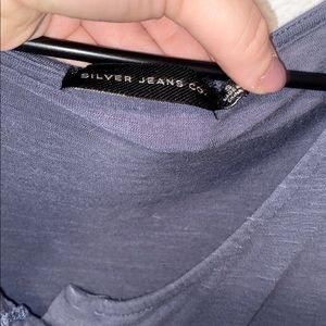 a cropped navy blue buttoned tee shirt